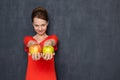 Portrait of happy woman smiling and offering to taste apples Royalty Free Stock Photo