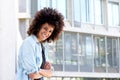 Happy woman standing outside by urban building Royalty Free Stock Photo