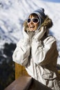 Happy Woman in the snowy mountains with sunglasses Royalty Free Stock Photo