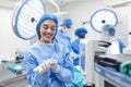 Portrait of happy woman surgeon standing in operating room, ready to work on a patient. Female medical worker in surgical uniform Royalty Free Stock Photo