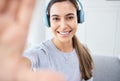 Portrait of happy woman take selfie and smile with headphones while listening to music in the living room. Young Royalty Free Stock Photo