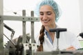 Portrait of happy woman technician checking industrial equipment Royalty Free Stock Photo