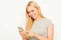 Portrait of happy woman typing sms on her smartphone Royalty Free Stock Photo