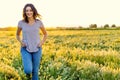 Portrait of a Happy woman walking among the wild flowers on a summer evening Royalty Free Stock Photo