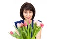 Portrait of a happy woman 35-40 years old with a large bouquet of fragrant tulips