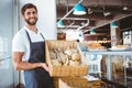 Portrait of happy worker holding basket of bread Royalty Free Stock Photo