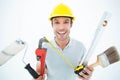 Portrait of happy worker holding various equipment Royalty Free Stock Photo