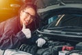 Portrait happy working woman work for auto mechanic job in garage hand thumbs up sign for good condition car engine