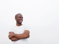 Happy young african american man laughing with arms crossed against white background Royalty Free Stock Photo