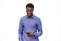 Happy young african american man looking at cellphone against isolated white background Royalty Free Stock Photo