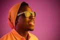 Portrait of a happy young african american man smiling on black neon background Royalty Free Stock Photo