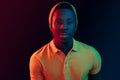 Portrait of a happy young african american man smiling on black neon background Royalty Free Stock Photo