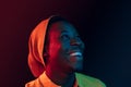 Portrait of a happy young african american man smiling on black neon background Royalty Free Stock Photo