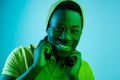 Portrait of a happy young african american man smiling on black neon background Royalty Free Stock Photo
