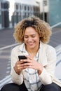 Happy young african american woman looking at cellphone outside Royalty Free Stock Photo