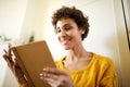 Happy young african american woman reading book at home Royalty Free Stock Photo