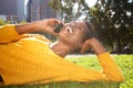 Happy young african american woman relaxing in park and talking with cellphone Royalty Free Stock Photo