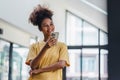 Portrait of happy young African american woman smiling confident using smartphone. afro american businesswoman reading a Royalty Free Stock Photo