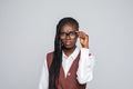 Portrait of happy young african business woman wearing glasses standing looking camera over grey background Royalty Free Stock Photo