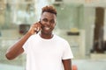 Happy young african man guy making a phone call and smiling Royalty Free Stock Photo