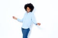 Happy young african woman dancing and enjoying against white background Royalty Free Stock Photo