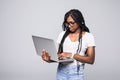 Portrait of happy young afro american woman using laptop computer isolated over white background Royalty Free Stock Photo