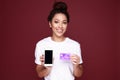 Portrait of an excited young african woman showing blank screen mobile phone isolated over pink Royalty Free Stock Photo