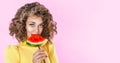 Portrait happy young afro girl is holding slice of watermelon over colorful pink background Royalty Free Stock Photo