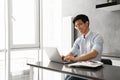 Portrait of a happy young asian man using laptop computer Royalty Free Stock Photo