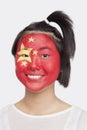 Portrait of happy young Asian woman with Chinese flag painted on face against white background Royalty Free Stock Photo