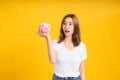 Portrait happy young asian woman holding piggybank saving money for future and business earning income Royalty Free Stock Photo