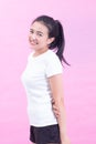 Portrait of happy young asian woman isolated on pink background