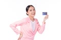 Portrait of a happy young asian woman wearing pink suit holding bank card, credit card isolated on white background. Business Royalty Free Stock Photo