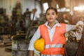 portrait happy young asian woman worker with heavy metal machine lathe milling factory industry Royalty Free Stock Photo