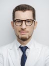 Portrait of happy young bearded male doctor smiling with eyeglasses isolated on white background Royalty Free Stock Photo