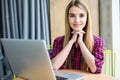 Portrait of happy young beauty woman using laptop at office table or cafe. Royalty Free Stock Photo