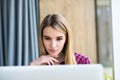 Portrait of happy young beauty woman using laptop at office table or cafe. Royalty Free Stock Photo