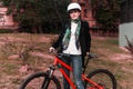 Portrait of happy young bicyclist riding in park