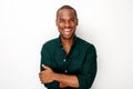 Happy young black guy smiling with arms crossed against isolated white background Royalty Free Stock Photo