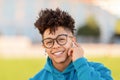 Portrait of happy young black student guy with wireless earbuds Royalty Free Stock Photo