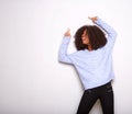 Happy young black woman pointing up and smiling against white background Royalty Free Stock Photo