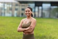 Portrait of happy young black woman in sports outfit posing at urban park Royalty Free Stock Photo