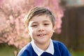 Portrait happy young boy looking at camera with smiling face, School kid standing in the front garden waiting for school bus in Royalty Free Stock Photo