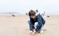 Portrait Happy young boy playing and digging sand on the beach in sunny day summer, Kid having fun with building a sand castle on Royalty Free Stock Photo