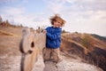 Portrait of happy young boy sitting on a wooden bench outdoors Royalty Free Stock Photo