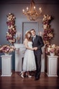 Portrait of happy young bride and groom in a classic interior near the fireplace with flowers. Wedding day, love theme. First day Royalty Free Stock Photo