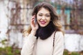 Portrait of happy young brunette woman in beige coat talking on Royalty Free Stock Photo