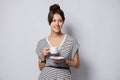 Portrait of a happy young business woman holding cup of coffee isolated over white background. Royalty Free Stock Photo