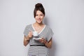 Portrait of a happy young business woman holding cup of coffee isolated over white background. Royalty Free Stock Photo