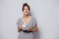 Portrait of a happy young business woman holding cup of coffee isolated over white background. Royalty Free Stock Photo